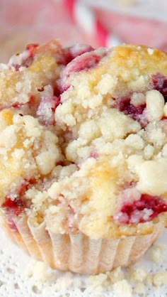 a muffin with crumbs sitting on top of a doily