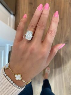 a woman's hand with pink manicures and a diamond ring