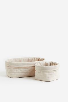 two white bowls sitting next to each other