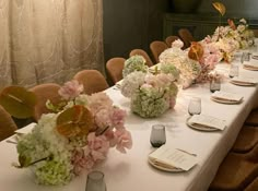 a long table with flowers and menus on it