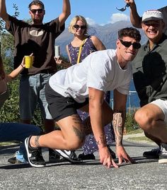 a group of people posing for a photo with their skateboards