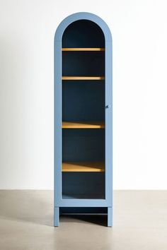 a blue bookcase with shelves in the middle