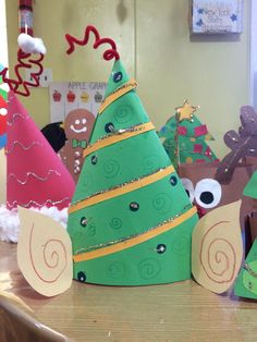 several paper christmas trees sitting on top of a table