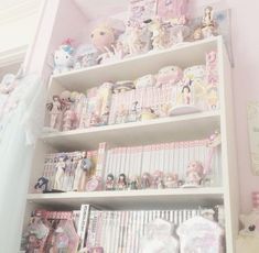 a shelf filled with lots of different types of toys and dolls on top of it