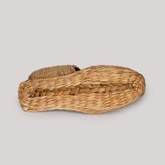 an empty basket sitting on top of a white surface