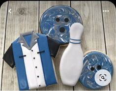 two decorated cookies with bowling pins and shirts