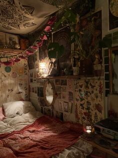 a bedroom with an unmade bed and lots of pictures on the wall