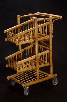 three wooden baskets stacked on top of each other in front of a black background with wheels