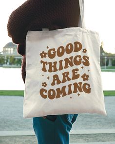 Good Things Are Coming Tote Bag - Aesthetic Tote Bag, Smile Tote, Trendy Tote Bag, Tote Bag Aesthetic, Happy Face Tote Bag, Hippie Bag DETAILS ✦ Very lightweight and compact bag! ✦ Perfect for books, laptops, etc.  ✦ Material: 100% Cotton canvas ✦ Measuring at 16"w x 15"h ✦ Short Handle Length: 20" ✦ Direct-to-garment printing - no vinyl, decal, or iron-on technique ✦ Please note that colors may appear different on different digital screens and may not be a true representation of the actual colo Vintage Bags With Letter Print For Everyday Use, Everyday Vintage Bags With Letter Print, Vintage Everyday Bags With Letter Print, Retro Rectangular Bag With Letter Print, Retro White Bag With Letter Print, Retro White Bags With Letter Print, Retro Everyday Bag With Letter Print, Goth Punk Aesthetic, Bible Tote Bag