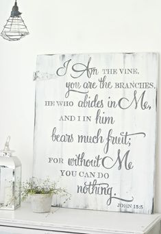 a white painted sign with the words i am the vine and you are the branches