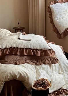 a bed with brown and white comforters on top of it