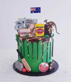 a green cake with chocolate icing and decorations on top, including an australian flag