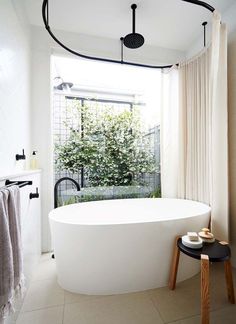 a white bath tub sitting next to a window