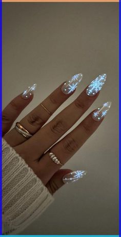 24. Snowflake Glow in Dark Nails Glitter Nail Art Ideas for Glimmering Festivities” invites you to adorn your nails with the magic of glitter, transforming them into radiant beacons of festive joy. Nails For New Years And Christmas, Easy Nail Snowflake Design, Basic Winter Acrylic Nails, Christmas Nails Glow In The Dark, Light Blue Glitter Ombre Nails, New Years Eve Wedding Nails, Christmas/new Years Nail Designs, Simple Aesthetic Christmas Nails, Snowflake Nails Almond Shape