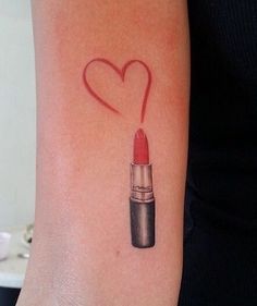 a woman's arm with a heart shaped lipstick tattoo on the left side of her arm