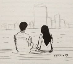 two people are sitting in the water looking at the city