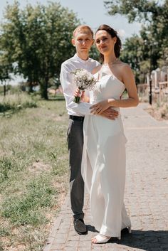 a bride and groom posing for the camera