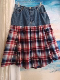 This comfortable skirt is made from women's denim pants and a flannel plaid men's button-down shirt.  The colors are red, white, and blue.  This part of the skirt is 55% cotton and 45% polyester. The size is 12 and the exact measurements are: Waist: 29 inches, around Hips: 42 inches, around Length: 31 inches at the longest point in front and back, a bit shorter on the sides, 29 inches. The skirt has pockets in the usual places of jeans plus the chest pocket on the men's shirt.  Thank you for vis Reworked Skirt, Jamestown Ny, Flannel Skirt, Comfortable Skirts, Denim Pants Women, Men's Button Down Shirt, Plaid Flannel, Red White And Blue, Denim Pants