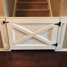 an open door leading up to a set of stairs with black handles on each side