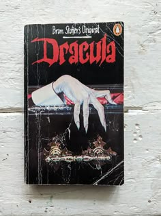 the book dracula is on display in front of a white wall