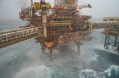 an oil rig in the middle of some choppy ocean water with waves around it