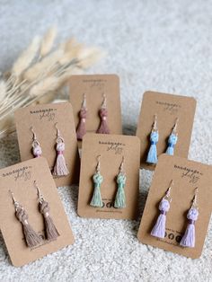 small earrings with tassels are displayed on the ground