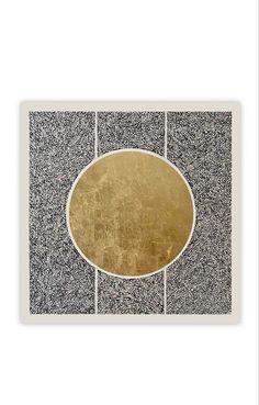 an abstract painting with black and white designs on it's sides, including a gold plate