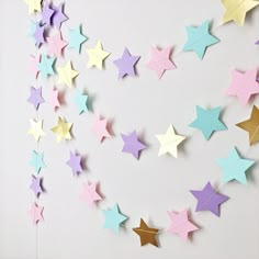 some paper stars are hanging on the wall and there is no image here to provide a caption for