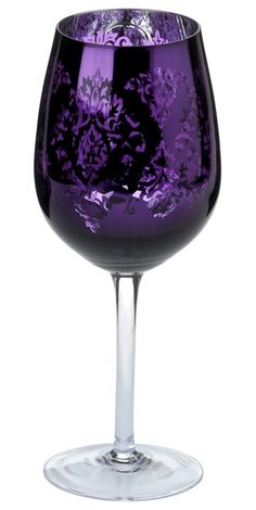 a purple wine glass sitting on top of a table