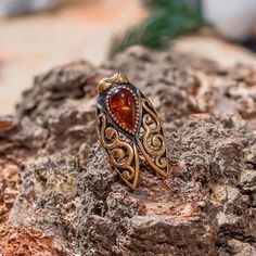 Introducing the Vintage Electroplated Cicada Ruby Ring, an exquisite piece of jewelry that is sure to turn heads. Crafted with attention to detail, this ring features an electroplated cicada design with intricate patterns and textures. The ruby stone is nestled in the center of the cicada's body, adding a pop of color and sparkle that catches the eye. The ring is made from high-quality metal that is plated with a vintage finish, giving it an aged and timeless look. The band is adjustable, so it Ruby Ring Vintage, Personal Transformation, Spiritual Cleansing, Gold Color Ring, Puka Shell, Engagement Party Wedding, Party Rings, Healing Power, Ruby Stone