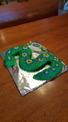 a cake shaped like a snake sitting on top of a table