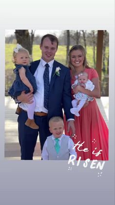 a man and woman are posing for a photo with their two children in front of them