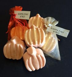 four different types of soaps sitting on top of a black table next to each other