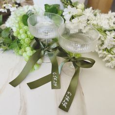 two wine glasses sitting next to each other on a table