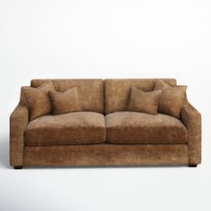 a brown couch sitting on top of a white floor