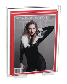 a magazine cover with a woman holding a cat on her shoulder and wearing black tights