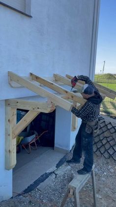 a man working on the roof of a house