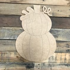 a paper cut out of an onion sitting on top of wooden planks