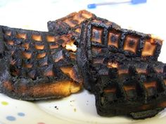 some waffles are sitting on a plate and one has been cut in half