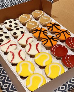 a box filled with cupcakes decorated like sports balls