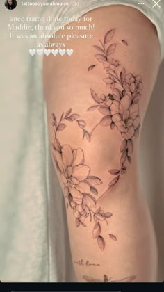 the back of a woman's thigh with flowers on it and an inscription that reads,