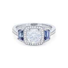 a diamond and blue sapphire engagement ring with diamonds on the sides, set in 18k white gold