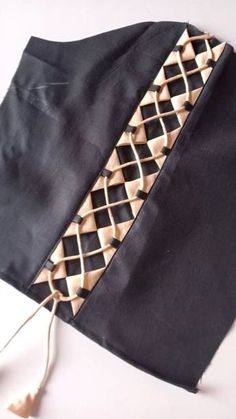 a piece of black cloth with gold trim