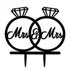 two wedding rings with the word mr and mrs written on them in cursive font