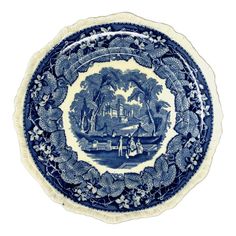 a blue and white plate with a landscape on it