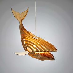 a light that is hanging from the ceiling with a fish design on it's side