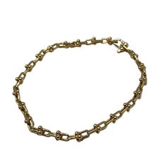 a gold chain bracelet on a white background