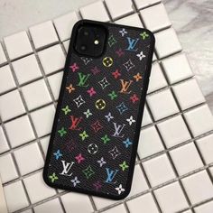 the louis vuitton phone case is on top of a white tile countertop