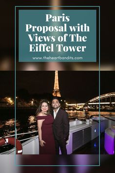 two people standing next to each other in front of the eiffel tower at night