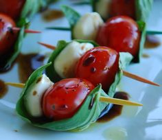 small appetizers with tomatoes and cheese on toothpicks are ready to be eaten